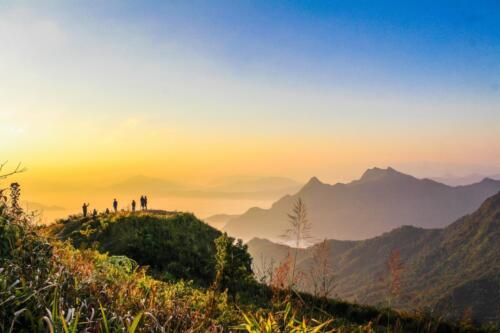 photo-of-people-standing-on-top-of-mountain-near-grasses-733162.jpg